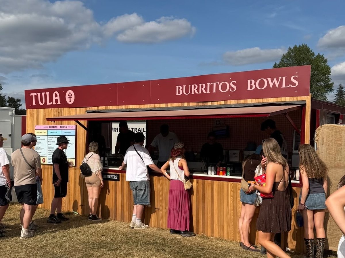 A queue at the Tula Mexican Grill trailer in the evening sun